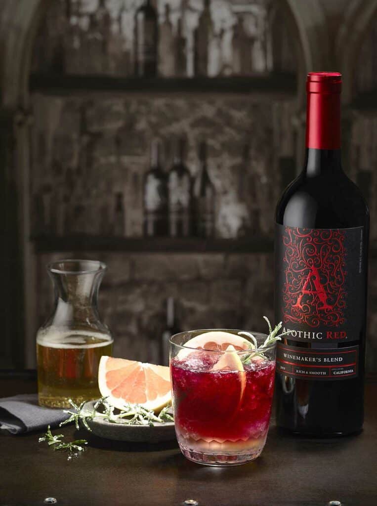 A glass of Apothic ginger sparkler with citrus and a bottle of Apothic Red