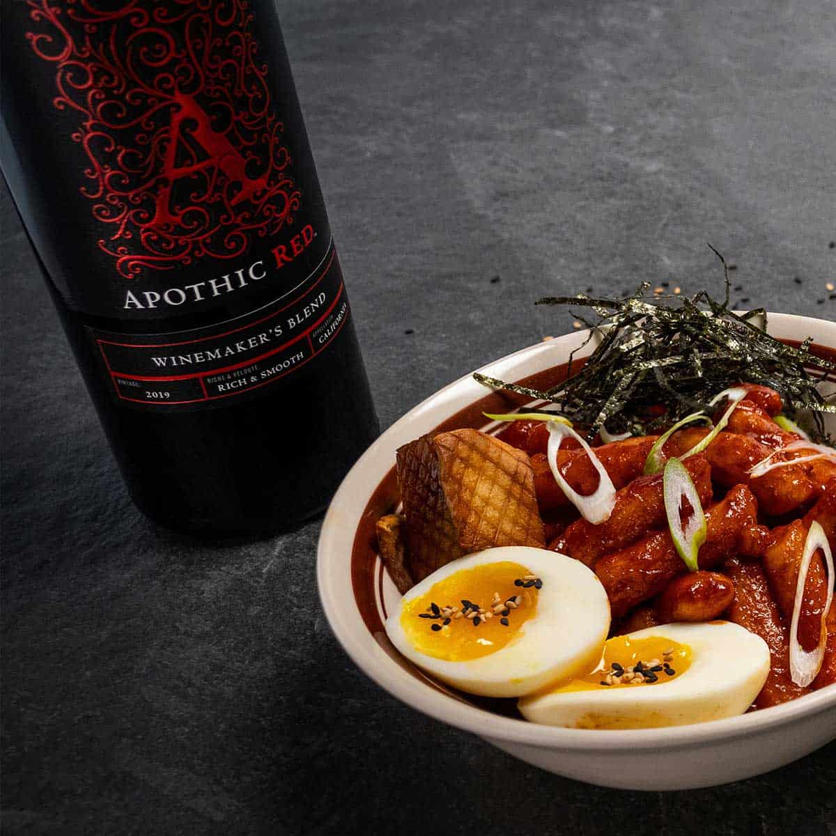 Tteokbokki bowl with apothic red bottle